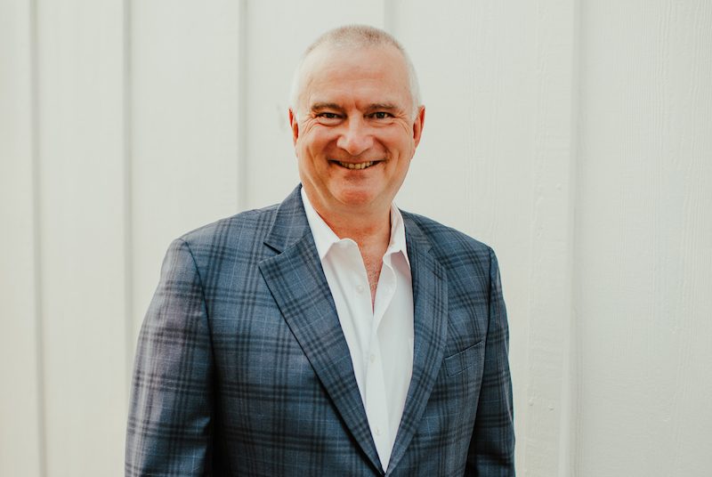 Portrait of Martin Fisher in a blazer, smiling